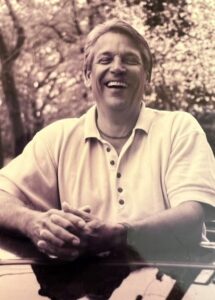 portrait of John Bolin smiling in sepia tone