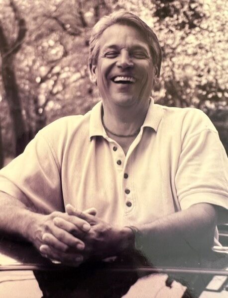 portrait of John Bolin smiling in sepia tone