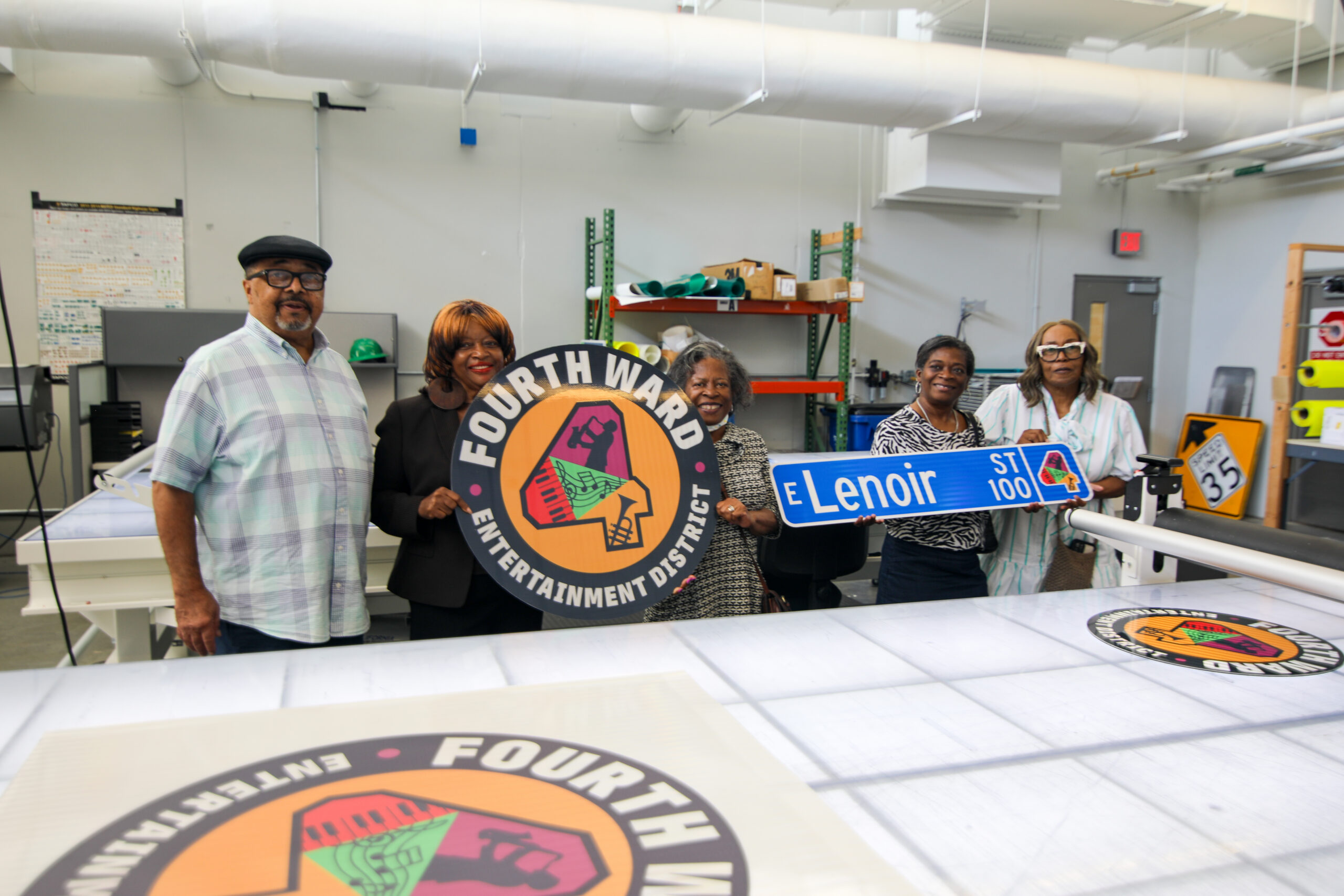 Members of the Fourth Ward Neighborhood Association holding commemorative street signs