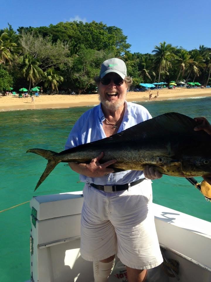 Bill Waldo smiling while holding fish on boat